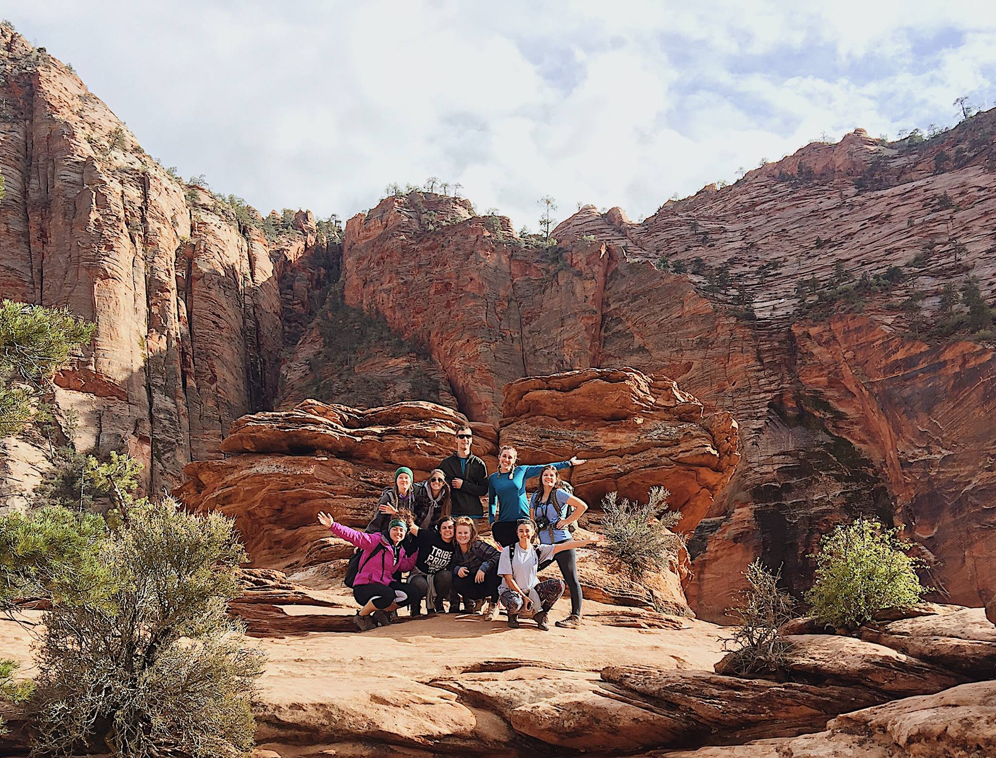 Students in front of red cliffs
