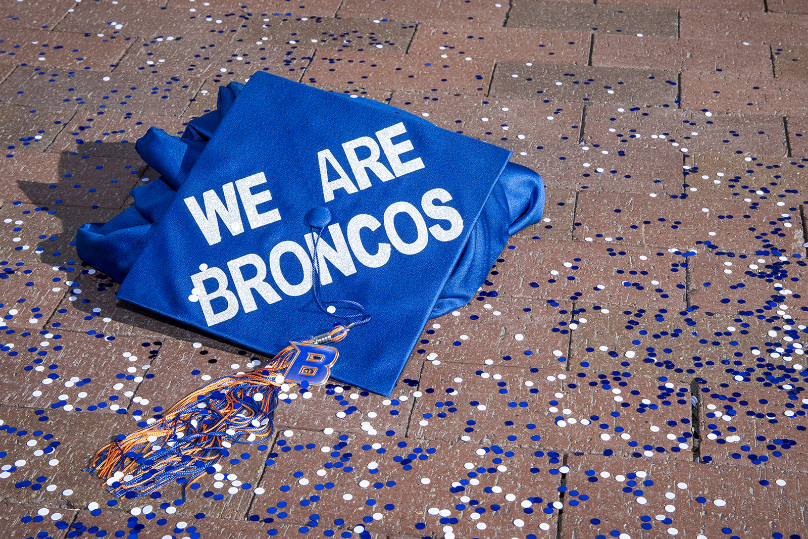 Graduation cap with the words we are broncos on top