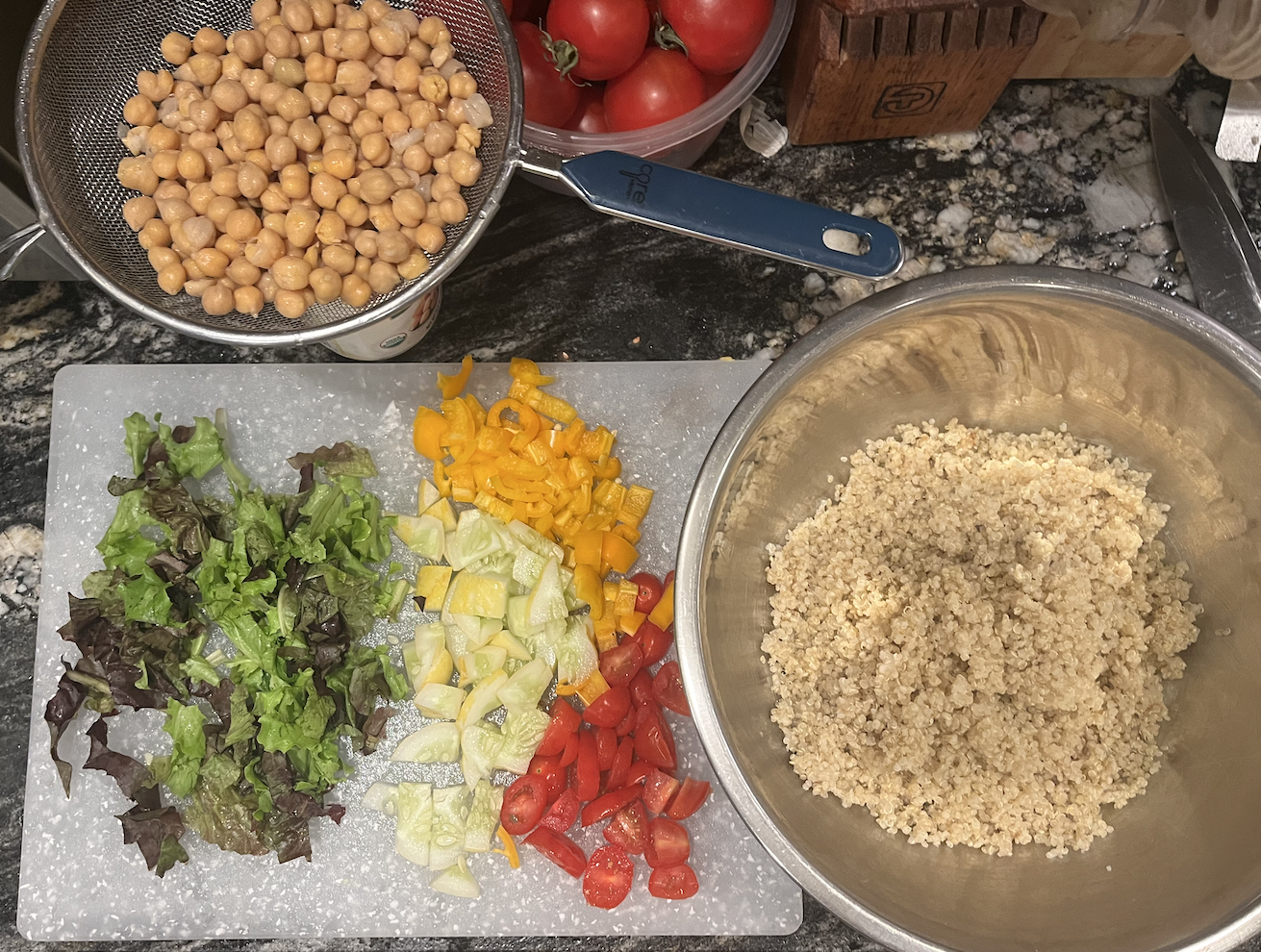 Chickpeas, Quinoa, and veggies prepared on a kitchen counter