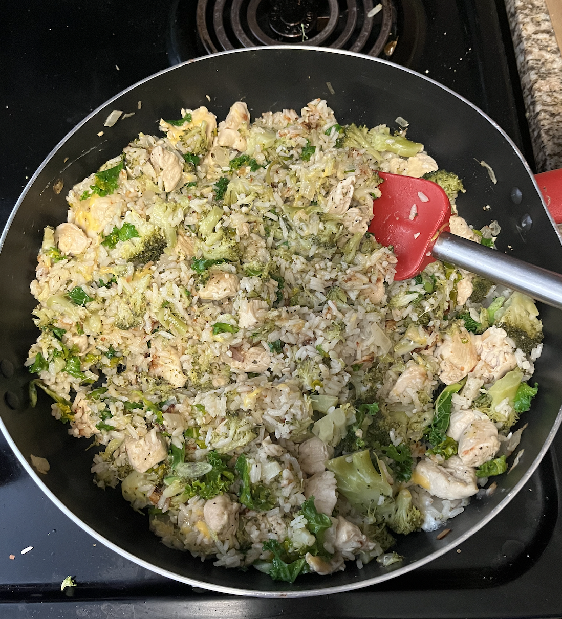 Chicken, rice, and broccoli in a pan