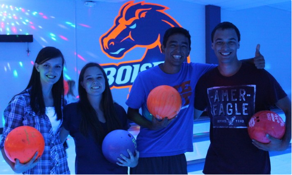 Students holding bowling balls at the Games Center