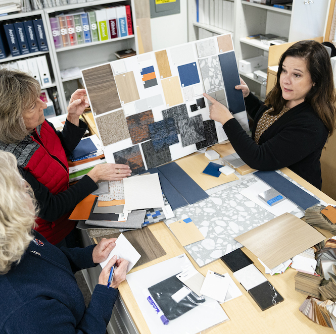 Persons view design samples at a table