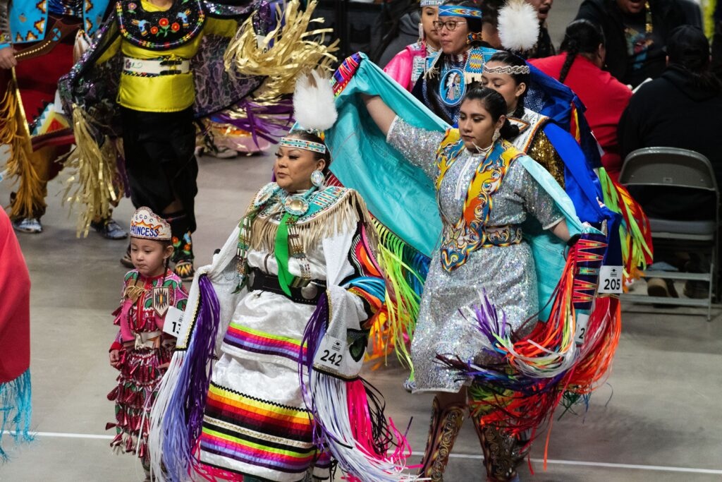 Native American dancers participate in a powwow