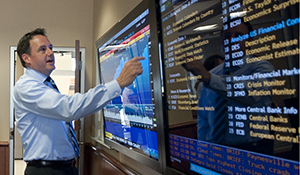 Keith Harvey in Financial Trading Room using Bloomberg touchscreen