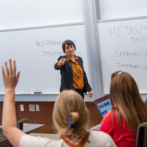Professor teaching, student with her hand up