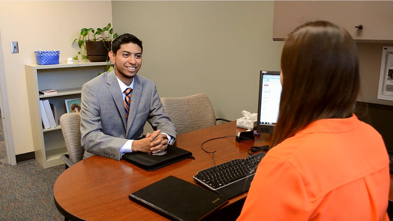 Student interviewing in an office
