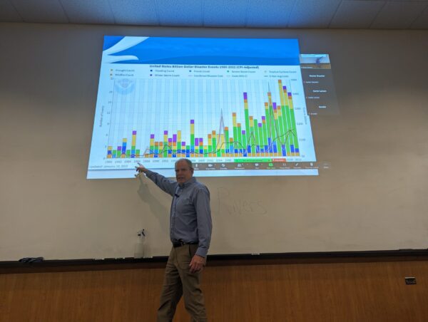 Another photo of Jay Breidenbach, a meteorologist at NOAA's NWS Boise office, lecturing in front of a projector image.