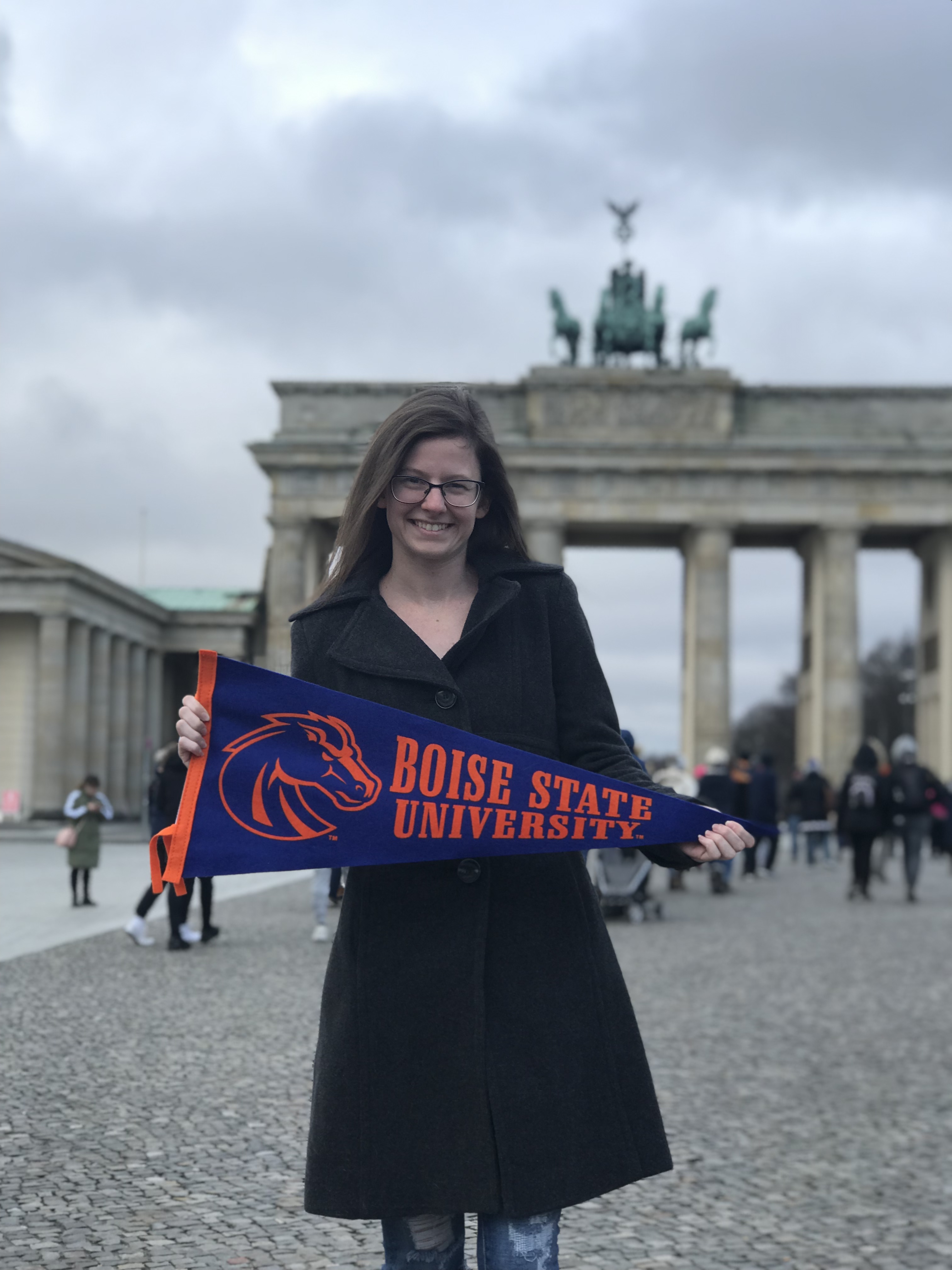 Student holding boise state banner in Berlin Germany