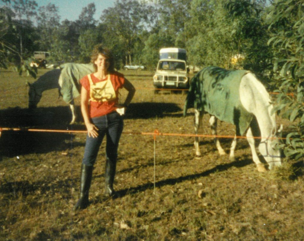 Kate standing near two horses