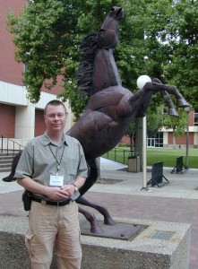 Dr. White standing in front of Bronco Scultpture