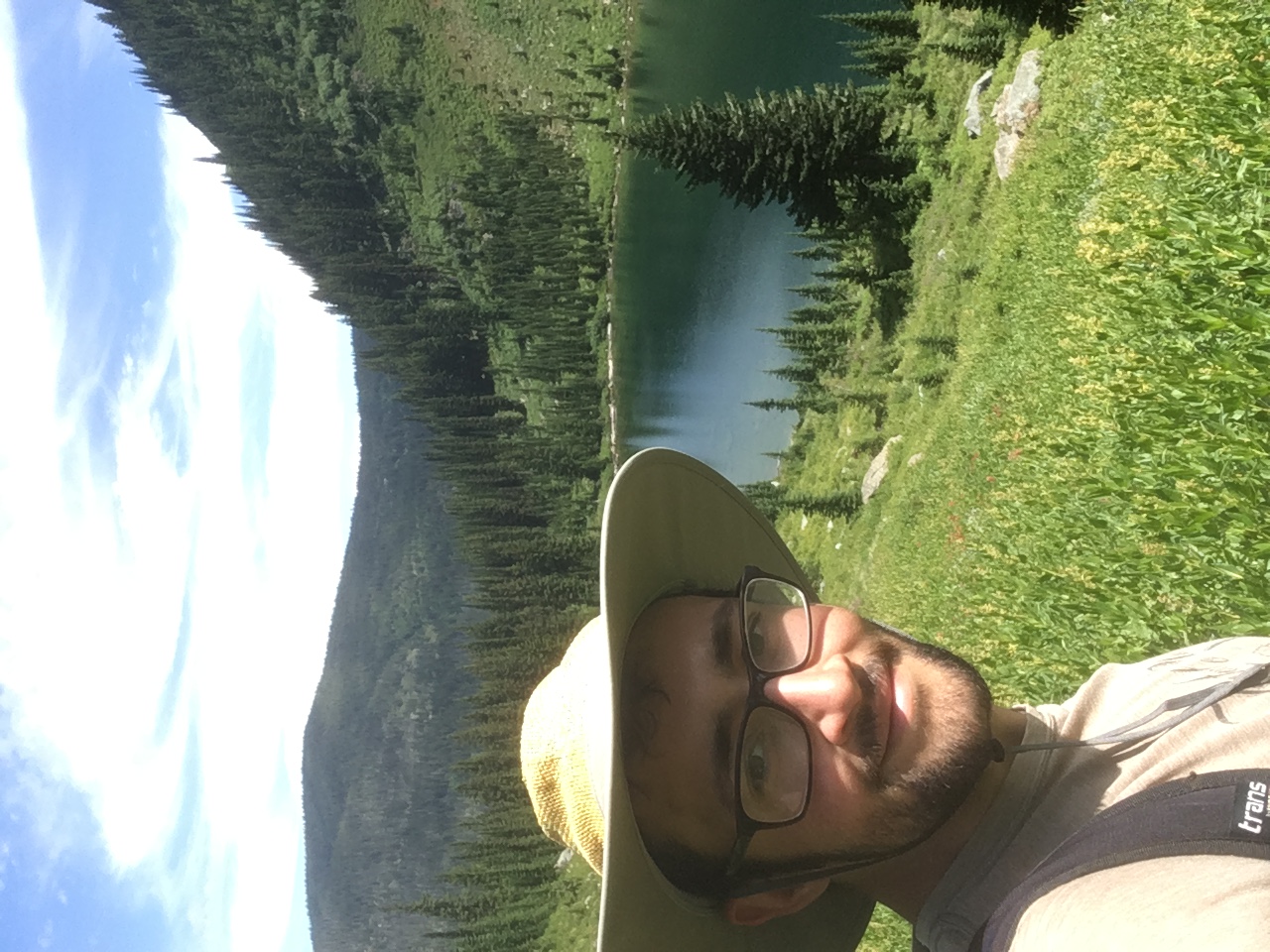 Photo of the author with mountains and a lake behind him