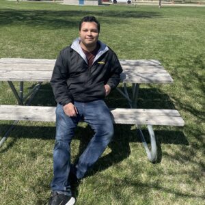 Ricard Rodriguez sitting at a picnic table at the park