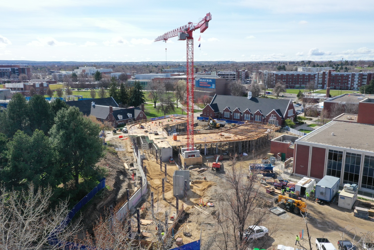 A drone camera image of construction site with crane and Boise State campus