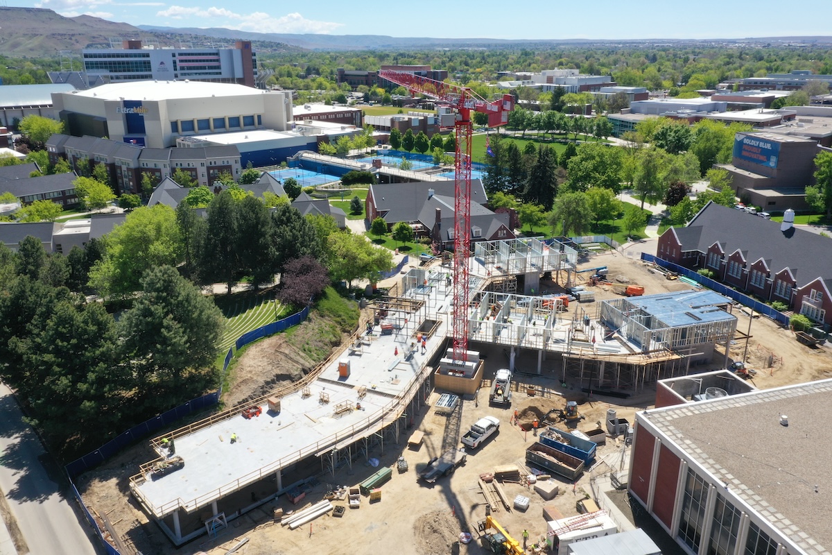 Aerial shot of construction site with large crane in background
