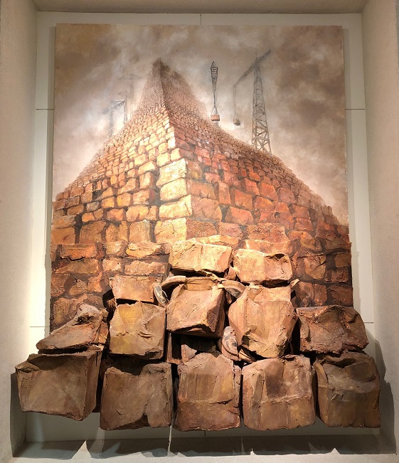 a sculptural, two-dimensional image of bricks towering in front of electricity poles