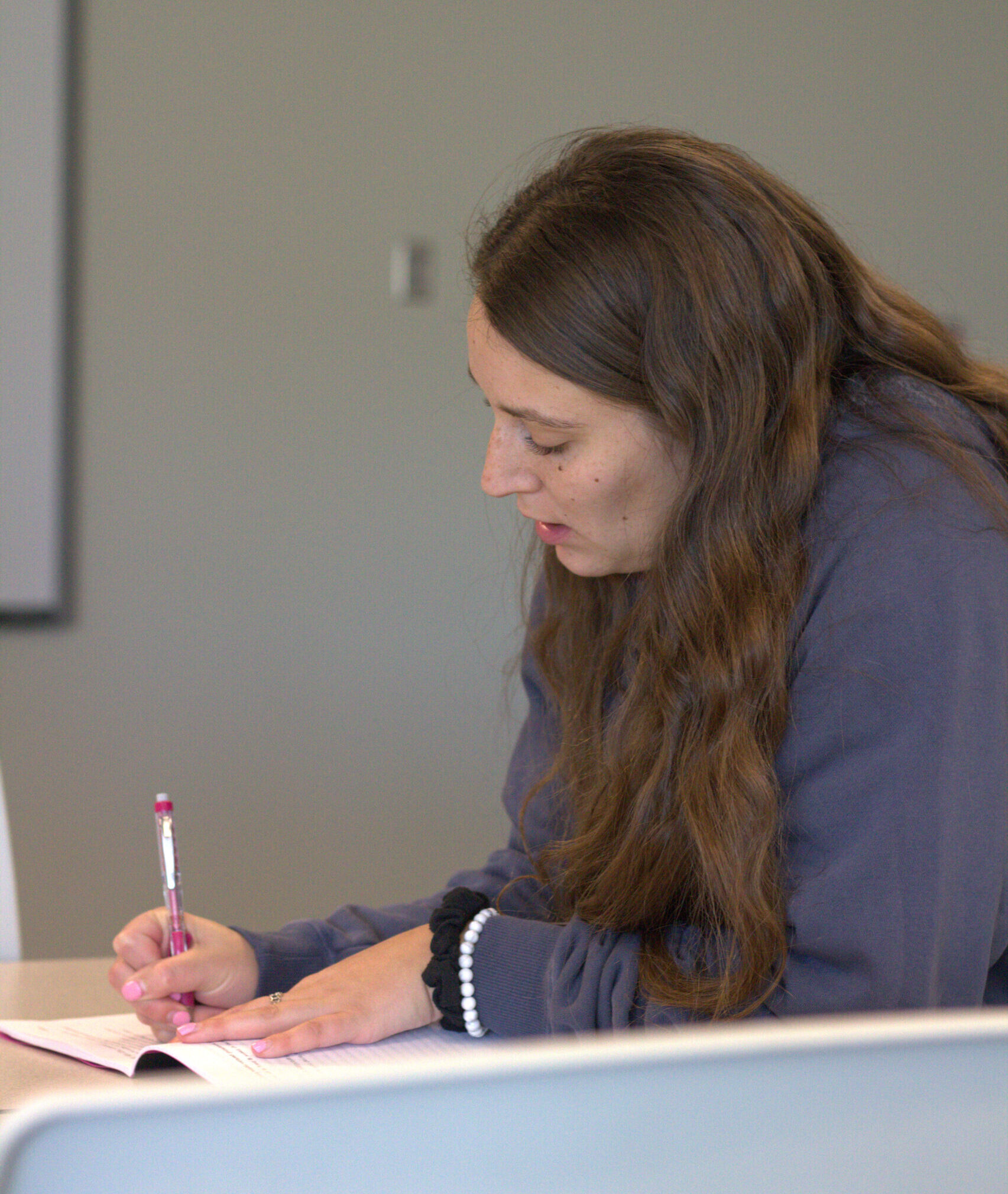Faculty member writes notes from a workshop