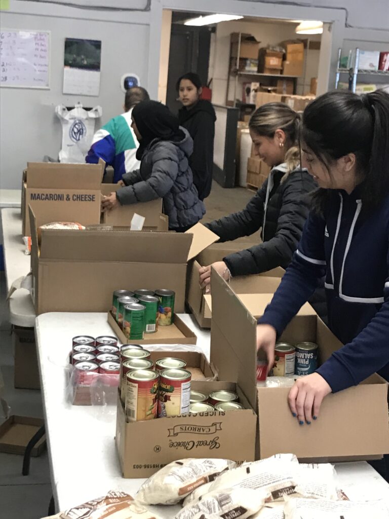 Students filling boxes at a food pantry