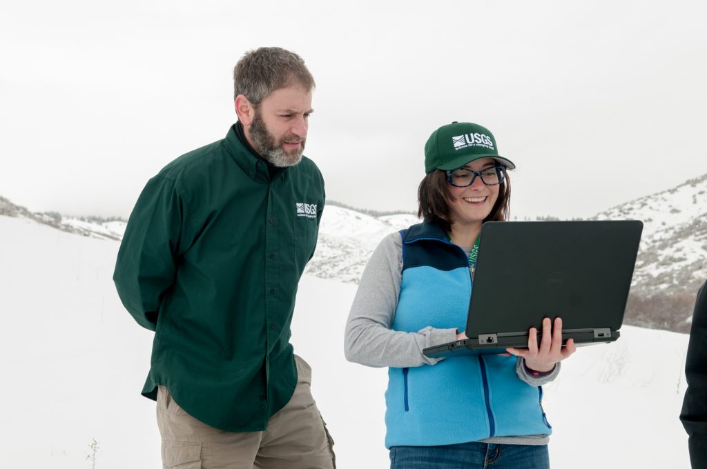 USGS scientist in field with students