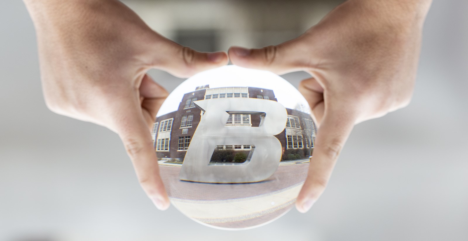 Boise State B statue reflected in a glass orb