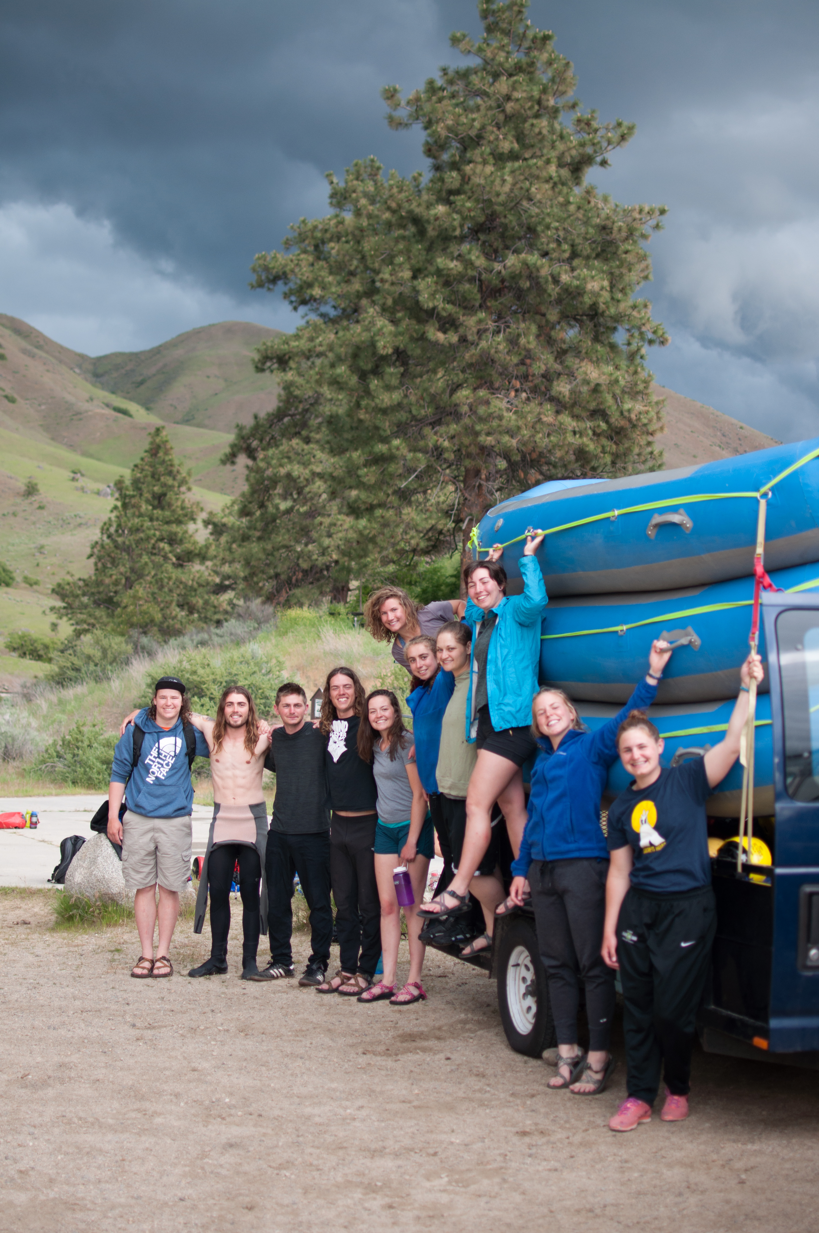 A group of people posing for a picture before a rafting trip.