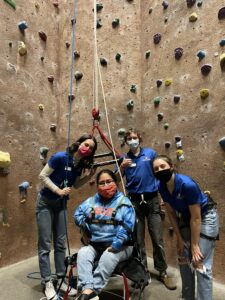 Group of four using adaptive climbing equipment