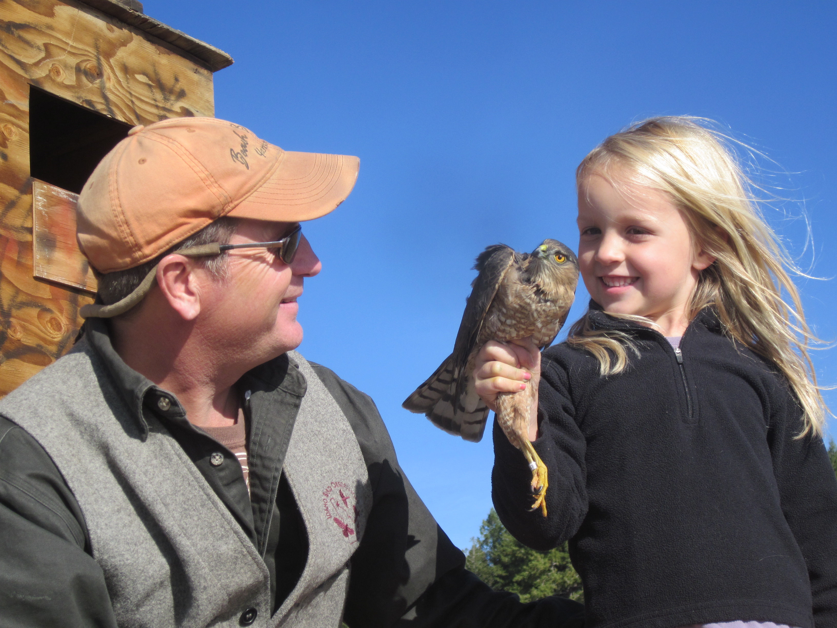Greg Kaltenecker and child holding a bird