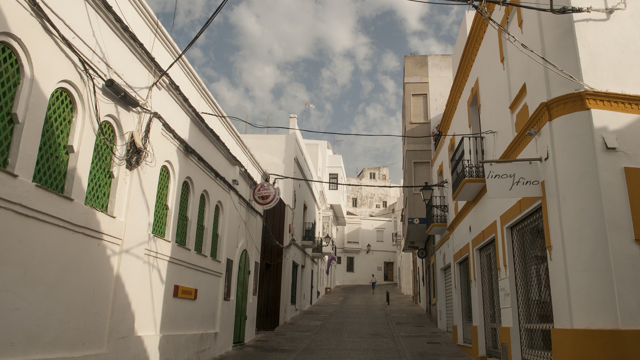 Old, narrow streets bounded by multi-story shops and residences in Tarifa, Spain