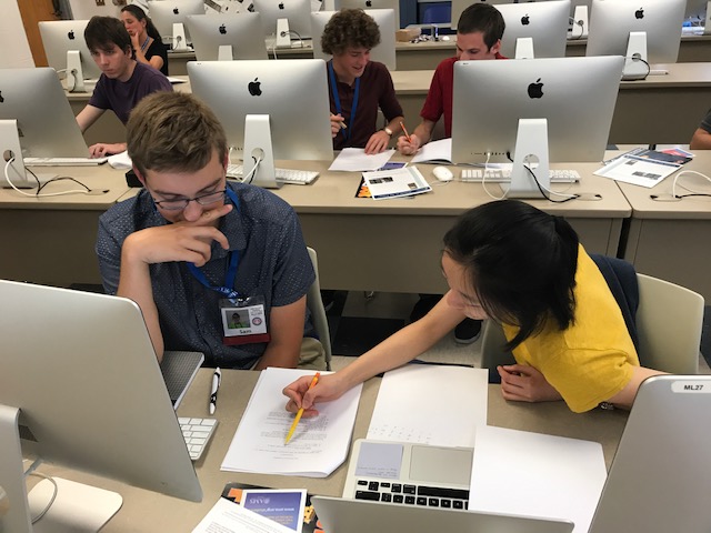 Students working with computer and notebook