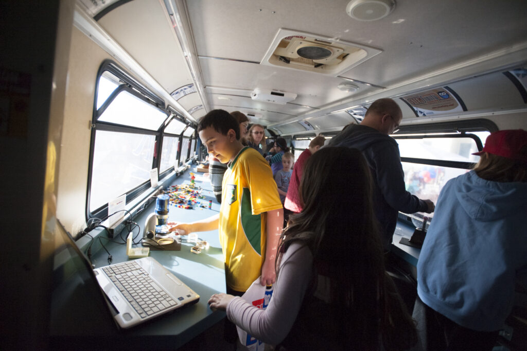 Students complete STEM projects inside a bus
