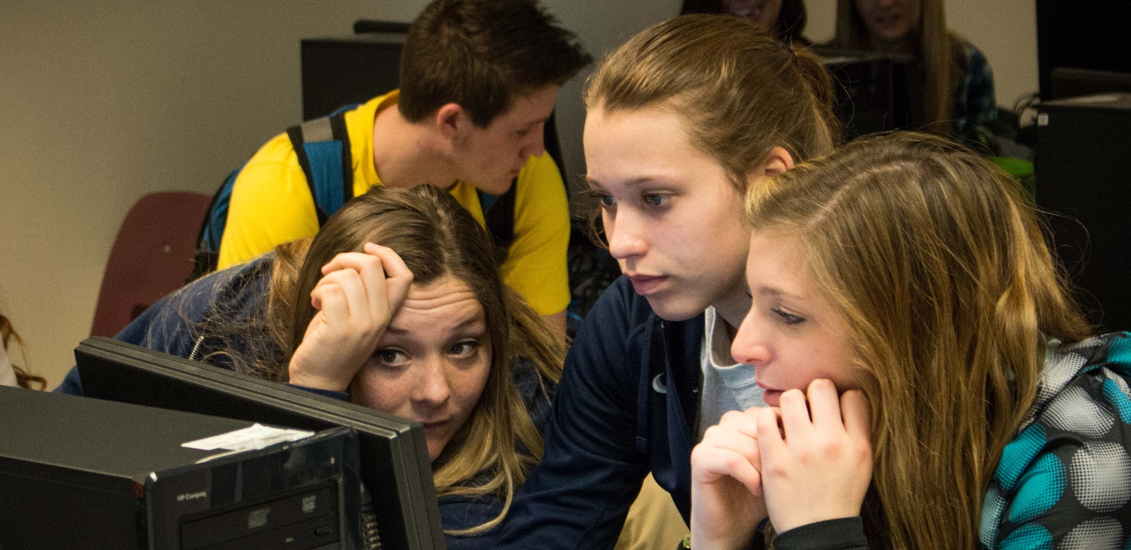 teens looking at a computer screen