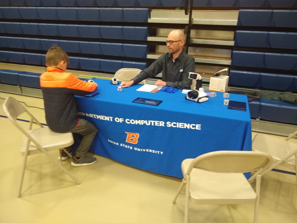 Computer Science teacher talking to elementary student