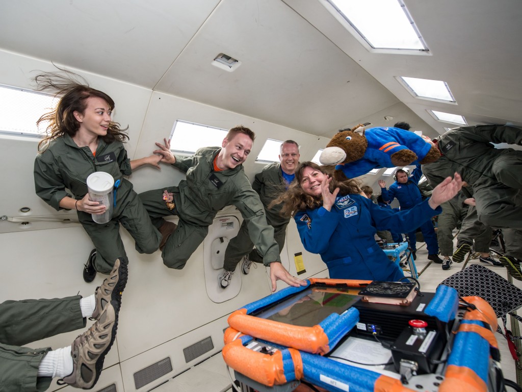 Students floating in NASA's weightlessness simulation plane