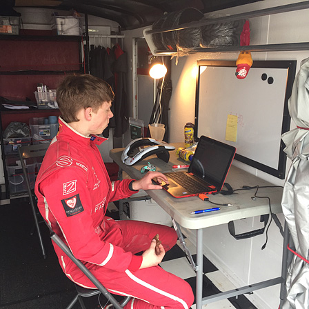 Stafford works on his laptop preparing for a race