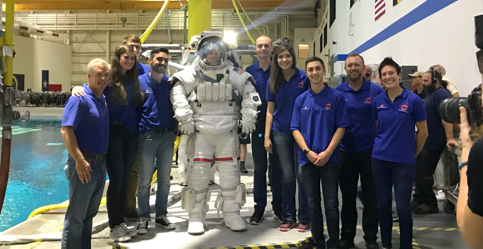 students at the NASA Johnson Space Center pose with astronaut