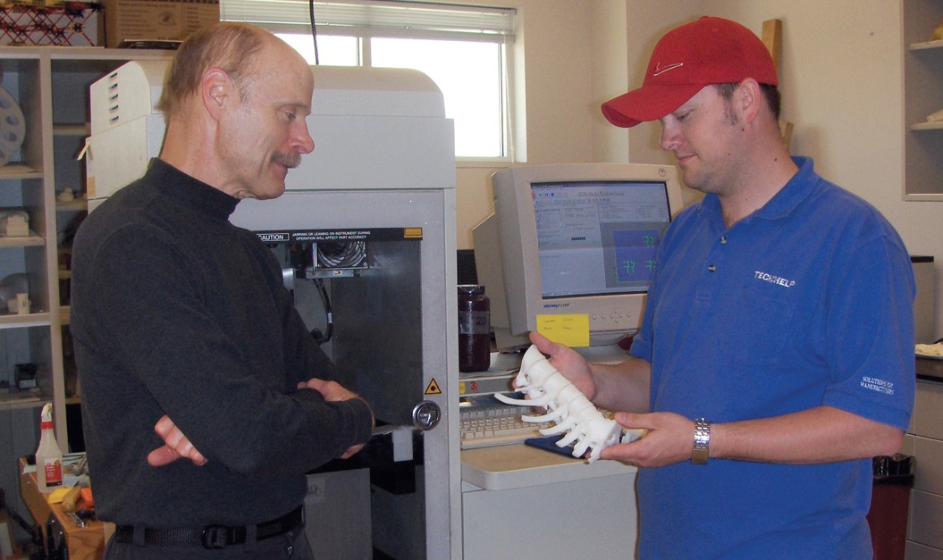 instructor and student with 3D printed spine section