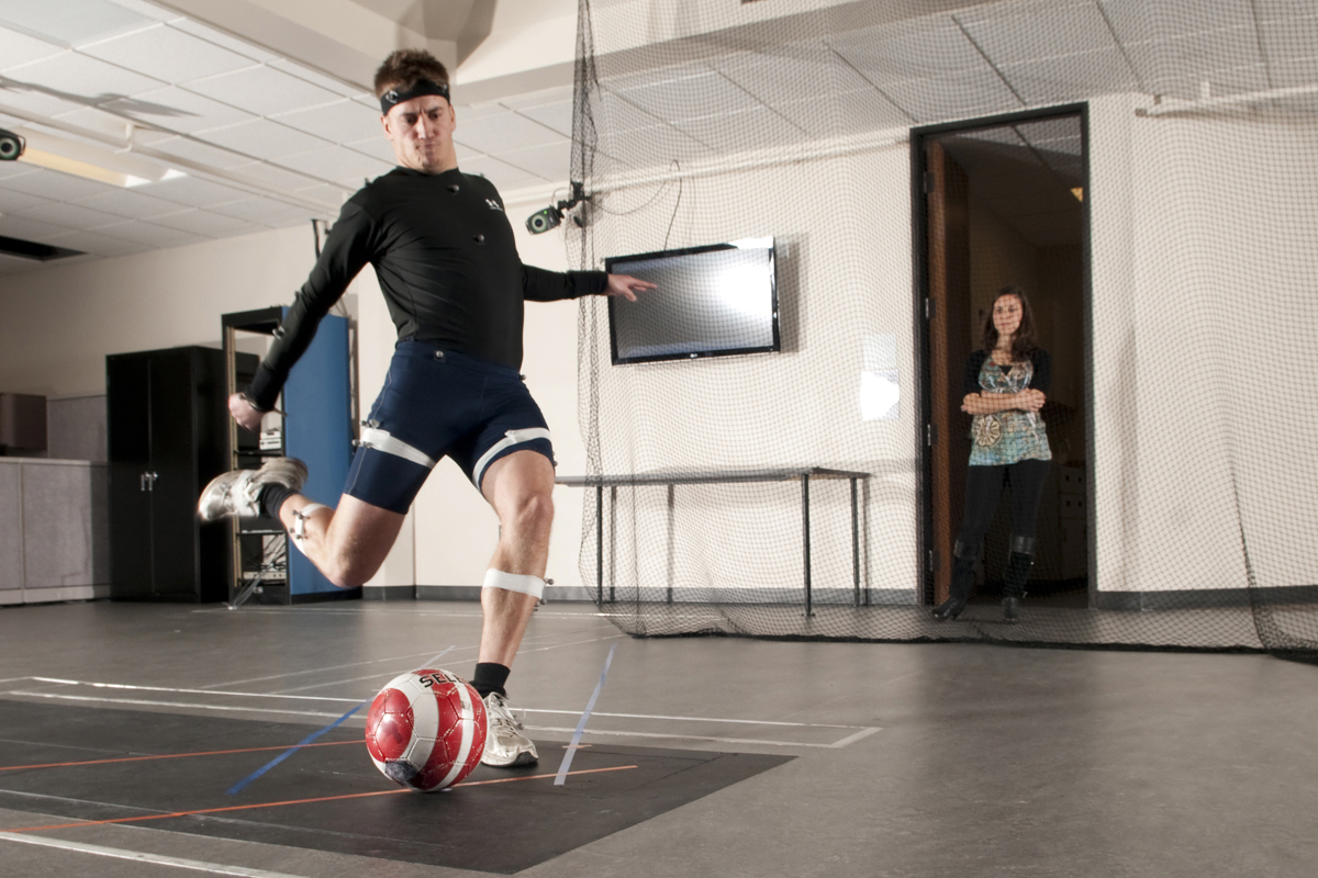 athlete kicking a ball while attached to sensors