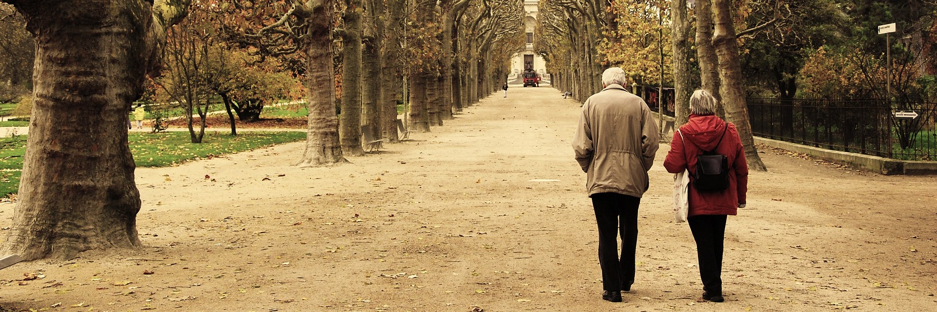 older couple walking down a road