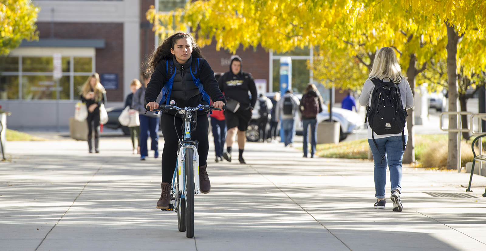 Student riding bike through campus