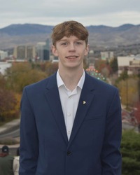 Corbin Lilya standing in front of city of Boise in background