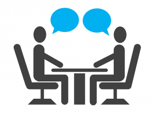 Picture of two stick figures sitting at a table across from one another with cartoon style blue callouts 
