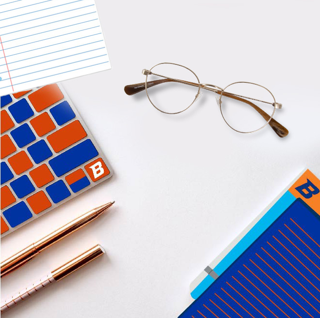 Glasses and Boise State office supplies sit on a table