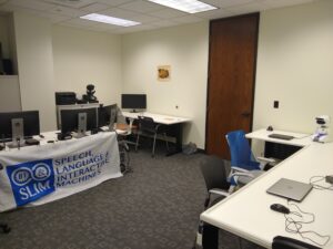 photo of lab with tables, computers, and robots