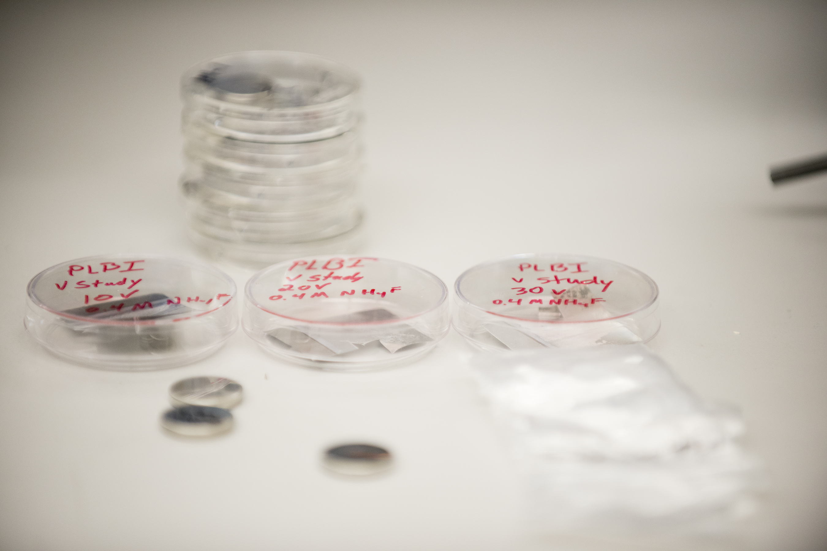 clear circular containers in an electrochemical energy materials laboratory