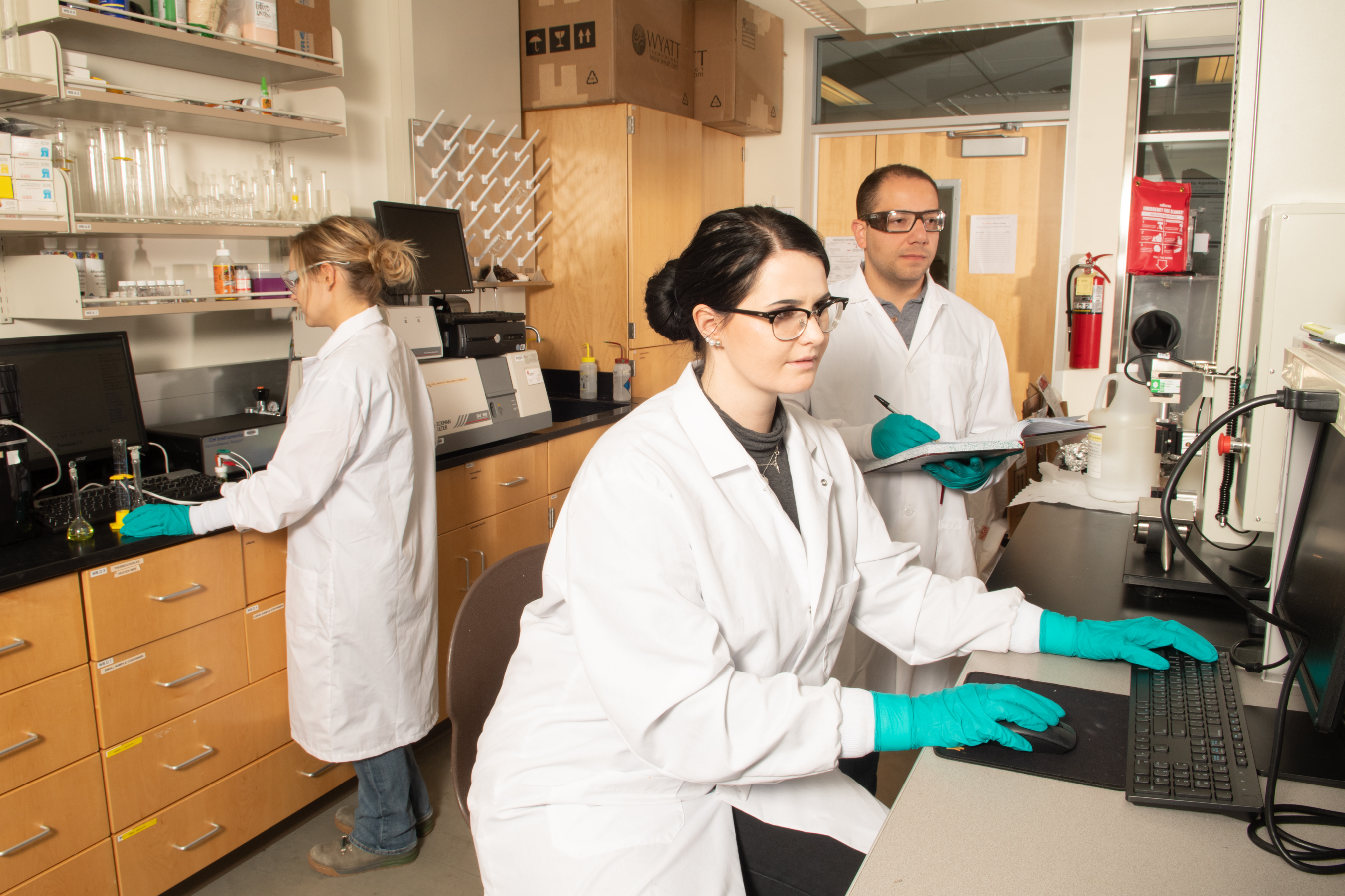 three people working in the Macromolecular Sciences Lab