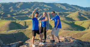 Students pose for a photo at the top of a hike