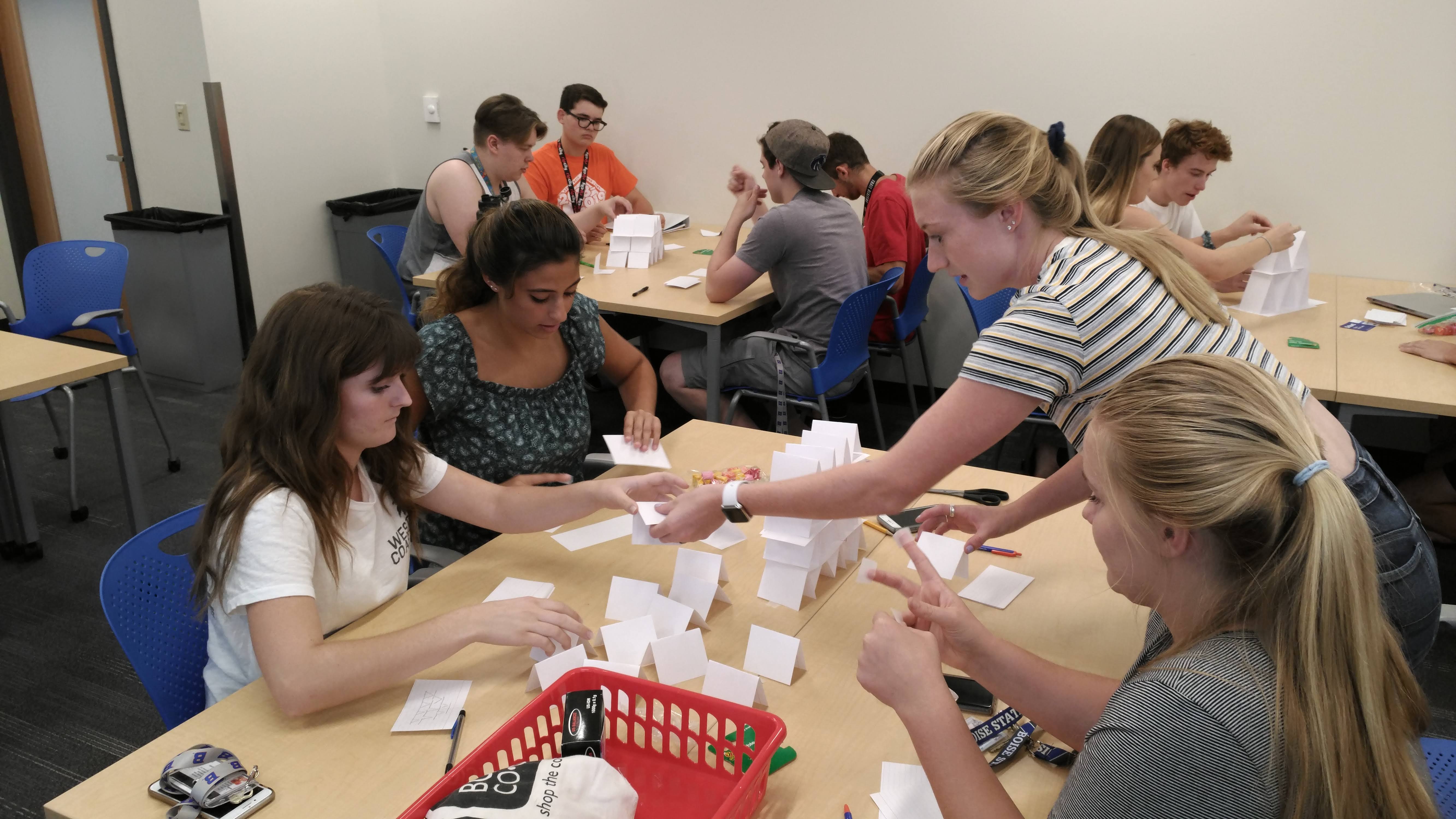 participants work together to create paper towers