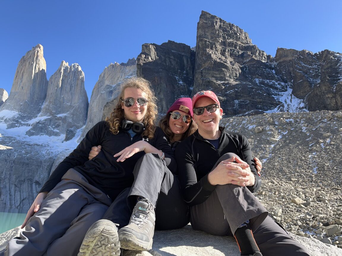 Dr. Matt Hansen with family members posing in front of scenic mountain