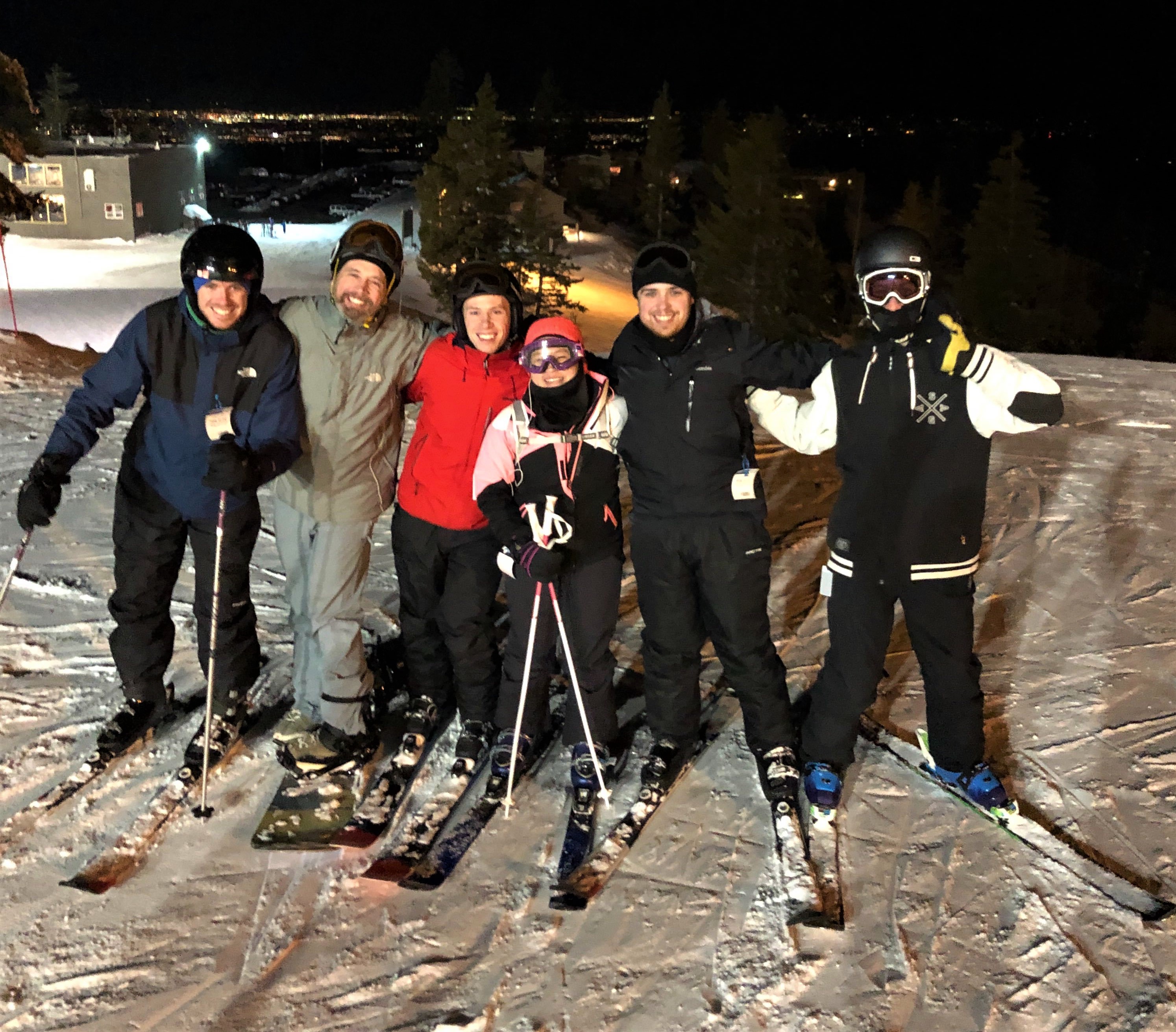 six people on skis and snowboard in snow