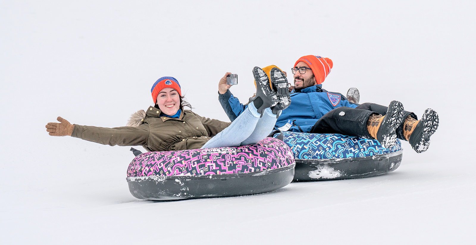 Students on inner tubes in the snow