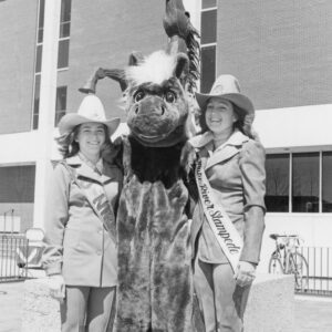 An historical photo of students with a bronco mascot.